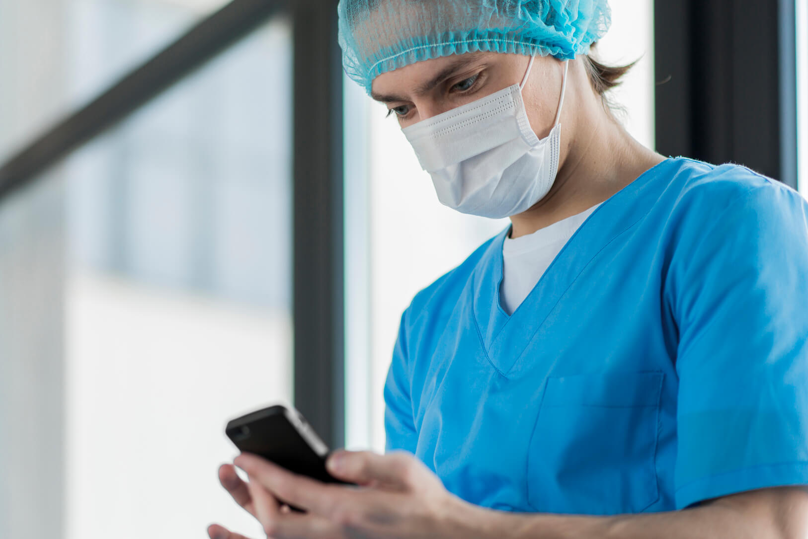 low-angle-nurse-checking-phone